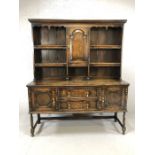 Dark wood sideboard / dresser with shelves and cupboard over and drawers and cupboards under, with