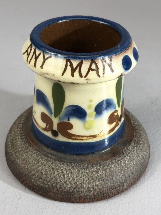 Watcombe pottery match striker marked 'A Match for any Man', approx 8cm in height