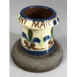 Watcombe pottery match striker marked 'A Match for any Man', approx 8cm in height