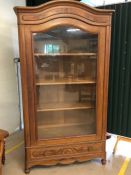 Mahogany cupboard with three shelves, drawer to base and single glass fronted door, approx 110cm x
