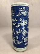 Chinese ceramic blue and white umbrella stand depicting blossoms, approx 22cm x 59cm