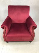 Burgundy velvet armchair with studded detailing