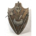 Metal mace, axe and knives, mounted on a wooden shield, approx 78cm x 50cm