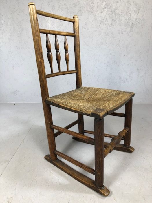 Antique rush seated child's rocking chair with turned supports, approx 81cm tall (A/F)