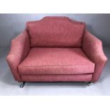 Red upholstered love seat, approx 125cm in length
