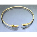 14ct Gold bangle with Dolphin ends approx 6cm wide and 3.4g