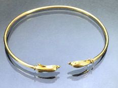 14ct Gold bangle with Dolphin ends approx 6cm wide and 3.4g