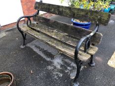 Wooden garden bench with wrought iron ends, approx 138cm in length