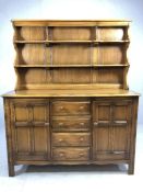 Ercol 'Golden Dawn' elm dresser with shelves over, four drawers and two cupboards under, approx