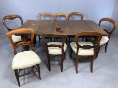 Victorian oak extending dining table on heavily carved legs and original castors with three