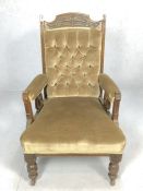 Antique upholstered armchair on castors