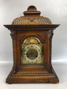 Continental oak cased mantel clock, brass dial with Arabic numerals, the brass movement stamped