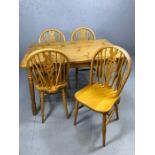 Pine kitchen table with four wheelback chairs, table approx. 120cm x 80cm