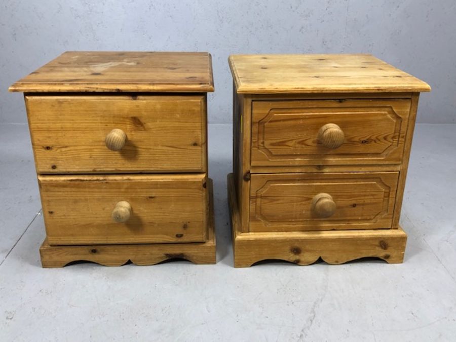 Two low pine bedside tables each with two drawers