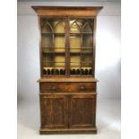 Breakfront bureau bookcase with cupboard and pull-out writing desk below and glazed book shelves