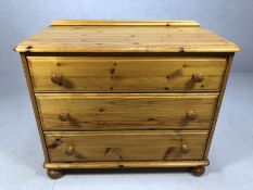 Pine chest of three drawers on bun feet, approx 90cm x 46cm x 75cm tall