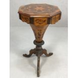 Octagonal inlaid sewing box / work table on heavily carved tripod legs, lid opening to reveal