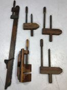 Vintage woodworking tools: a collection of three hand screws, a wooden sash cramp and a 'donkey's