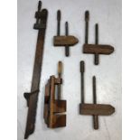 Vintage woodworking tools: a collection of three hand screws, a wooden sash cramp and a 'donkey's