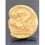 Small fragmentary artefact, circular, depicting two figures in an erotic scene, possibly Greco