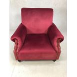 Burgundy velvet armchair with studded detailing