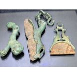 Collection of three razors, possibly Roman in origin, one in the form of a leopard or other wild cat