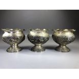 Three Indian silver bowls each marked V.75 and with Repousse decoration depicting Boars, Hunting