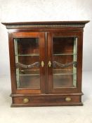 Mahogany display cabinet with glass doors, drawer under, with brass furniture and original key and