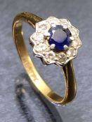 18ct Gold Diamond and Platinum set Sapphire ring with central Blue Sapphire surrounded by ten