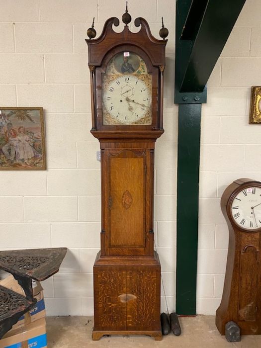 Longcase grandfather clock with painted face depicting Nelson, brass finials and column supports