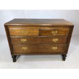 Solid wood chest of four drawers with brass handles, approx 106cm x 46cm x 78cm tall