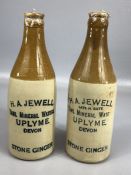 Two stoneware 'Stone Ginger' bottles, marked 'H.A. Jewell, Uplyme', the taller approx 20cm in