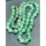 Jade bead necklace with 9ct gold clasp, approx 64cm long & 59g