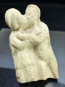 Fragmentary stone carving depicting lovers, possibly Greek, approx 11cm in height