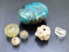 Collection of beads of varying ages to include a folded mosaic glass bead, a rock crystal bead and