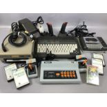 Vintage games consoles: Commodore plus/4 computer keyboard, 1541 disk drive, Datassette, joysticks