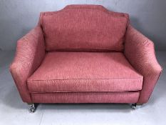 Red upholstered love seat, approx 125cm in length