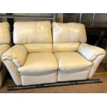 Modern cream leather two seater sofa, approx 153cm in length, with reclining seats