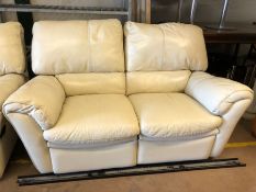 Modern cream leather two seater sofa, approx 153cm in length, with reclining seats