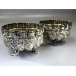 Pair of Indian Silver repousse bowls on tripod fish shaped feet and depicting Elephants, Tigers,