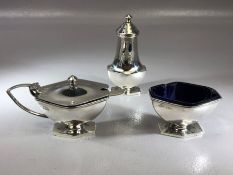 Three piece silver cruet set consisting salt, pepper and mustard (silver weight 140g) blue glass