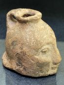 Greek aryballos in the form of a warriors head, with single handle and flat base, approx 5cm in