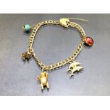 9ct Gold Charm bracelet with Gold charms (5) and a 9ct Gold Heart shaped lock approx 19cm long and