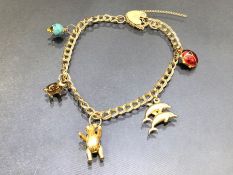 9ct Gold Charm bracelet with Gold charms (5) and a 9ct Gold Heart shaped lock approx 19cm long and