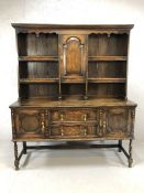 Dark wood sideboard / dresser with shelves and cupboard over and drawers and cupboards under, with