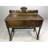 Antique oak writing desk on bobbin turned legs and splayed front feet with two drawers under and