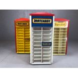 Three Matchbox diecast vehicle rotating retail counter display stands, each approx 65cm in height (