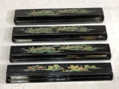 Four black lacquered oriental games holders, etched and painted with scenes of forests, mountains
