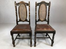 Pair of leather seated chairs with rush backs