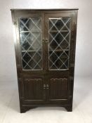 Linen fold cabinet with two leaded glass doors over and two doors under, approx 88cm x 34cm x
